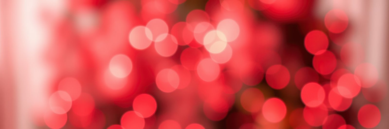 Bright red bokeh lights creating a warm and festive atmosphere during the holiday season